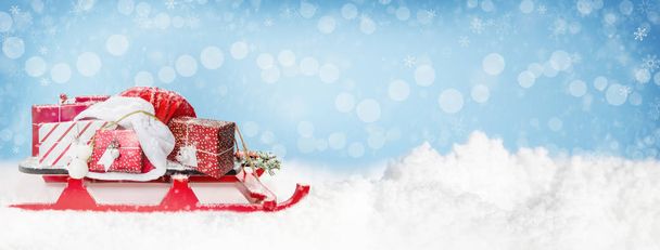 Christmas background horizontal web banner with Santa Claus sleigh and sack of presents - Photo, Image