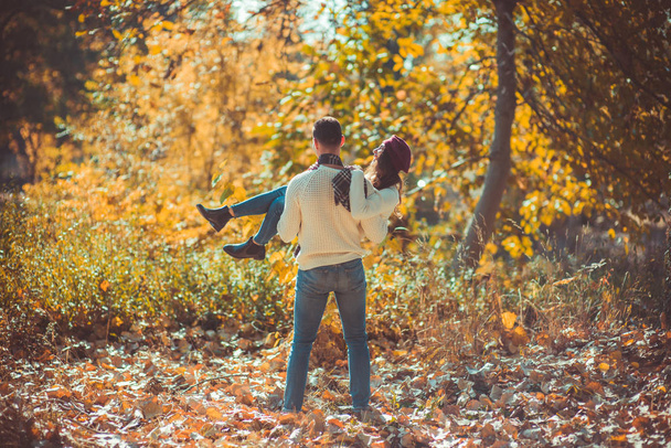 Stylish couple is outdoors into the woods and they are enjoying and having fun - Photo, Image