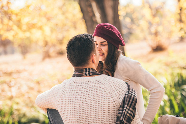 Classy couple is spending the day outdoors in the park, enjoying the day together - 写真・画像