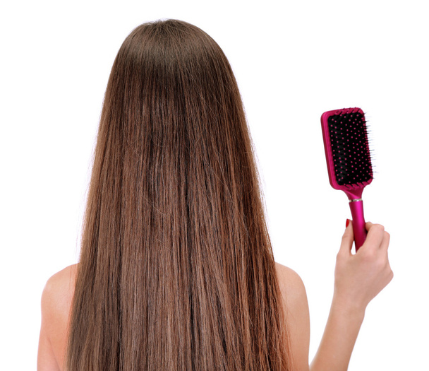 Portrait of beautiful woman with long hair and a hairbrush, isolated on white - Fotó, kép