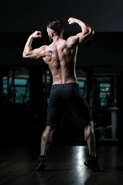 Portrait Of A Young Physically Fit Man Showing His Well Trained Body - Muscular Athletic Bodybuilder Fitness Model Posing After Exercises - Foto, Imagem