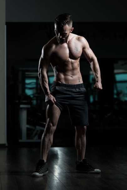 Portrait Of A Young Physically Fit Man Showing His Well Trained Body - Muscular Athletic Bodybuilder Fitness Model Posing After Exercises - Zdjęcie, obraz