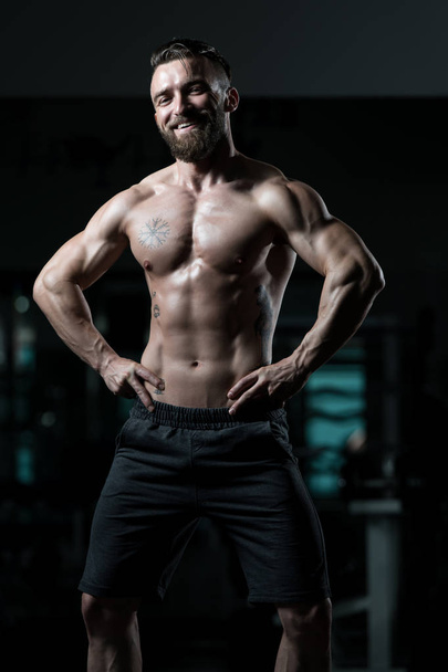Portrait Of A Young Physically Fit Man Showing His Well Trained Body - Muscular Athletic Bodybuilder Fitness Model Posing After Exercises - Zdjęcie, obraz