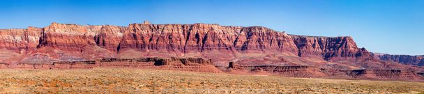 The Vermilion Cliffs are steep eroded escarpments consisting primarily of sandstone, siltstone, limestone, and shale which rise as much as 3,000 feet  above their bases. These sedimentary rocks have been deeply eroded for millions of years, exposing  - Photo, Image