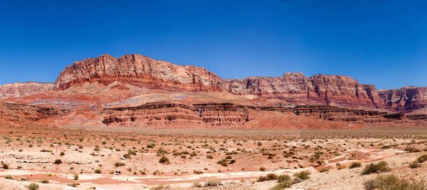The Vermilion Cliffs are steep eroded escarpments consisting primarily of sandstone, siltstone, limestone, and shale which rise as much as 3,000 feet  above their bases. These sedimentary rocks have been deeply eroded for millions of years, exposing  - Photo, Image
