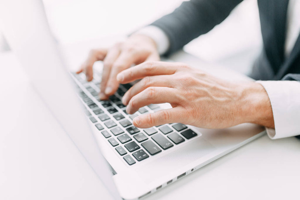 Hands at work on a laptop with bokeh. Business situation, isolated background. - Photo, Image