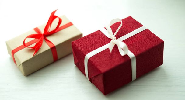 Christmas presents wrapped in paper lying on a white table - Foto, Imagen