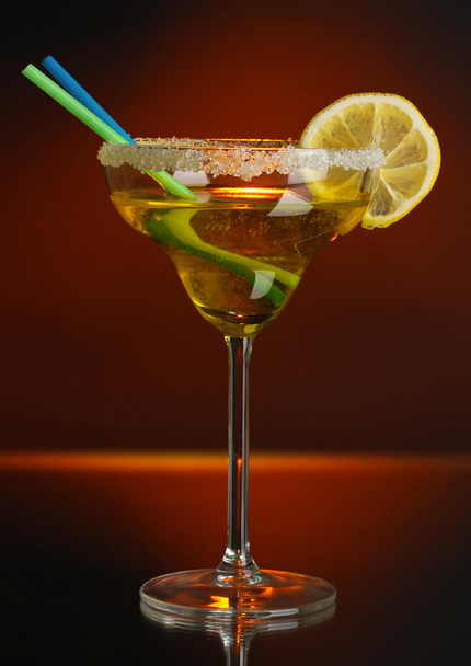 Yellow cocktail in glass on color background - 写真・画像