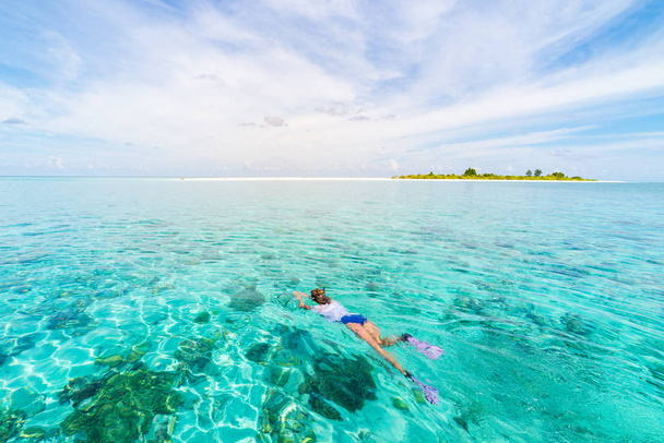 Woman snorkeling on coral reef tropical caribbean sea, turquoise blue water. Indonesia Wakatobi archipelago, marine national park, tourist diving travel destination - Photo, Image