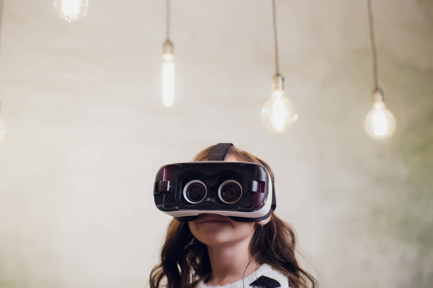 Young woman using a virtual reality headset with conceptual network lines. - Photo, Image