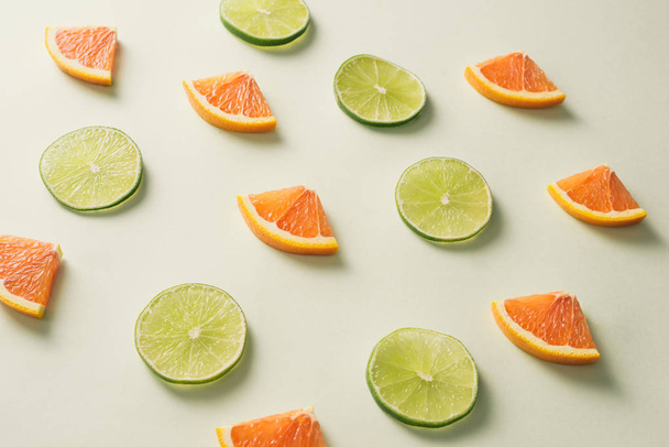 Composition with slices of citrus fruits on white background - Photo, Image