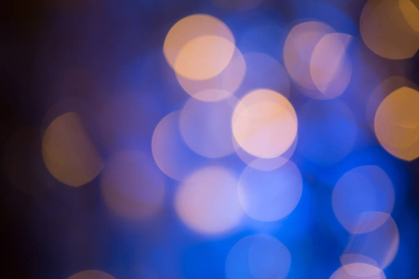 Blue Festive Christmas Beautiful abstract Background with bokeh lights. Holiday Texture with copy space. Wallpaper with Glitter light spots, defocused - Photo, Image