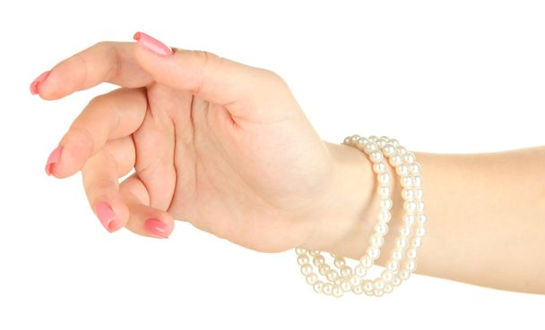 Female hand with pink manicure and bright bracelets, isolated on white - Φωτογραφία, εικόνα