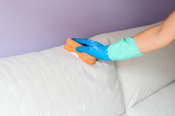 cleaning the sofa with a foam sponge - Photo, image