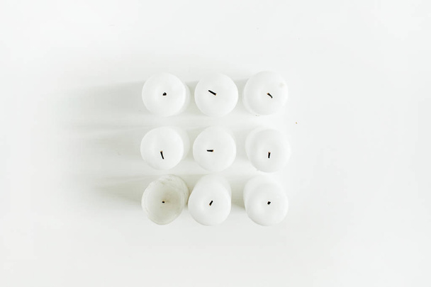Candles on white background. Flat lay, top view Christmas / New Year festive composition. - Photo, Image