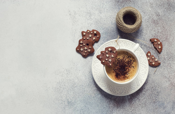 Christmas background with cup of coffee, chocolate cookies and spool of thread on grey stone background. Flat lay. Copy space - Foto, Imagem