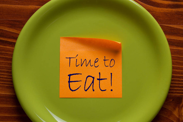 Time to eat written on note in plate. Eat concept. - Photo, Image