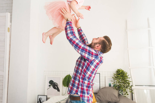 Cute little girl and her dad are having fun at home. - Foto, Imagen