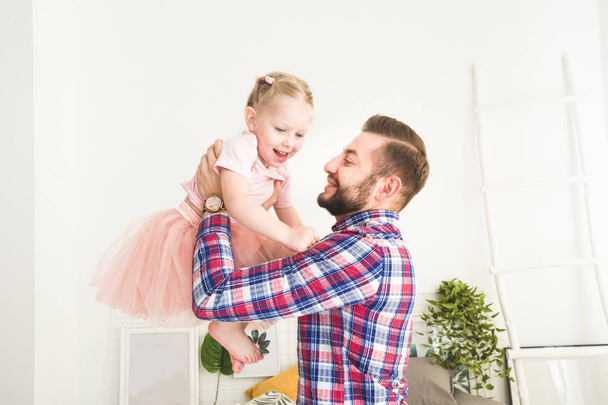 Cute little girl and her dad are having fun at home. - Fotoğraf, Görsel