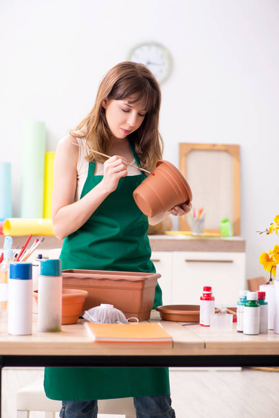 Jeune femme décoration poterie en atelier
 - Photo, image