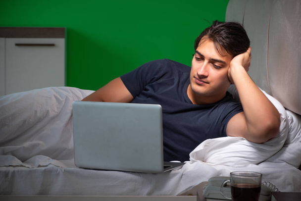 Fiatal jóképű férfi szenved álmatlanságban otthon - Fotó, kép
