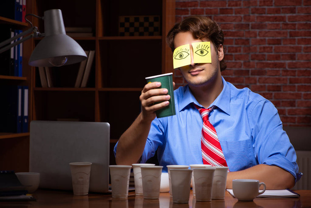 Молодий працівник п'є каву, що працює на нічній зміні
  - Фото, зображення