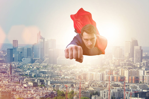 Homem de negócios super-herói voando sobre a cidade
 - Foto, Imagem