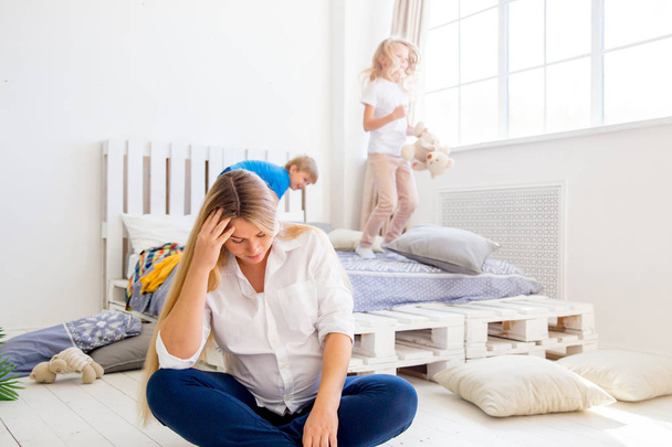Young pregnant mother is tired because her kids play - Φωτογραφία, εικόνα
