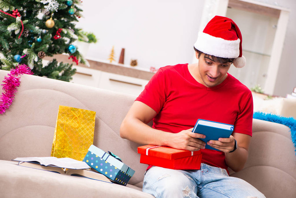 Young student with book at Christmas eve  - Photo, Image