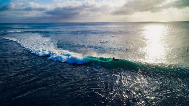 Surfer ride on waves in ocean sunset, top view - Fotó, kép