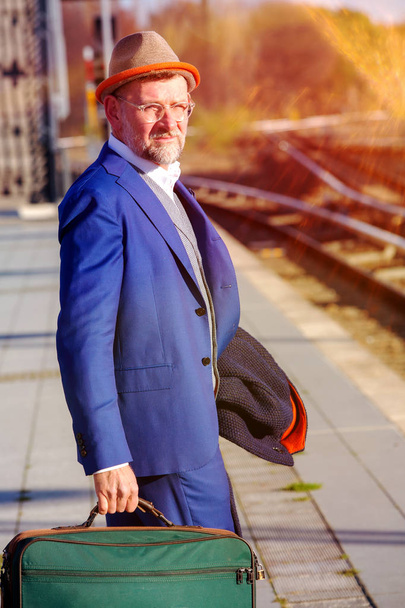 handsome man in his 50s waiting at train station - Fotografie, Obrázek