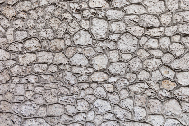 Stone wall background or texture, quaility stonework with large, ornamental curved joints - Foto, afbeelding