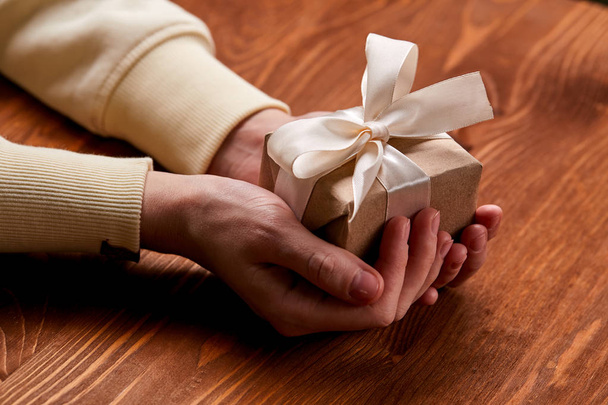 hands holding craft gift box, close-up  - Φωτογραφία, εικόνα