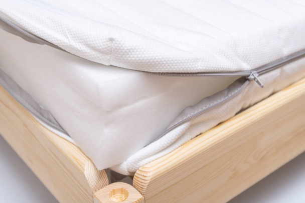 Inside of foam mattress on wooden bed - Photo, Image