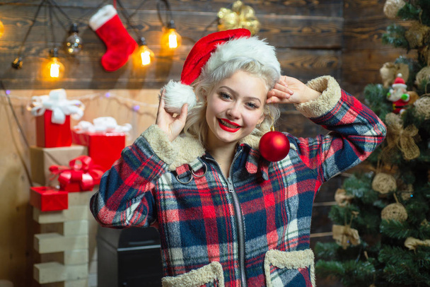Christmas decorations and gift box on wooden background. Funny Laughing Surprised Woman Portrait. Emotions. Christmas happy. Young woman with christmas present boxes in front of christmas tree. - 写真・画像
