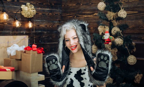 Celebration. Smiling girl winter. Christmas woman dress. December surprise and party time. Christmas decorations and gift box on wooden background. Sensual girl for Christmas. - Фото, изображение