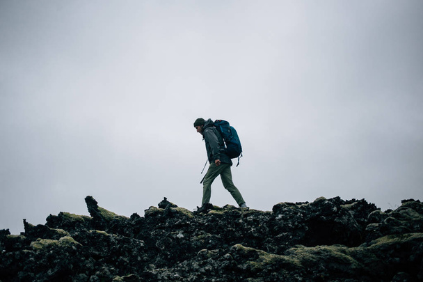 Young man hikes through rough iceland terrain - Foto, Bild