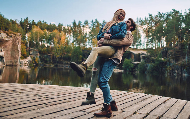 Young couple of tourists are exploring new places. Attractive young woman and handsome bearded man are spending time and having fun together on nature. - Фото, изображение