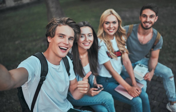 Group of young people are studying together in university. Students outdoors making selfie. - Foto, imagen