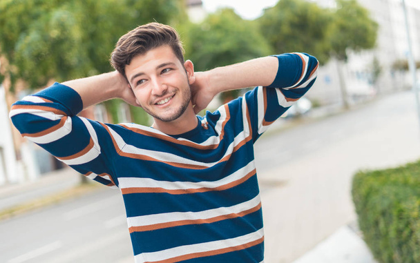 Happy beautiful man posing on the street with smile, outdoor - outside - Фото, изображение
