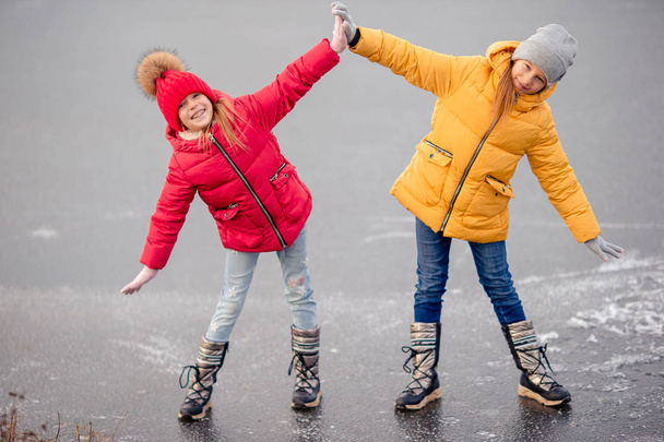Adorable little girls skating on the ice-rink - Photo, Image