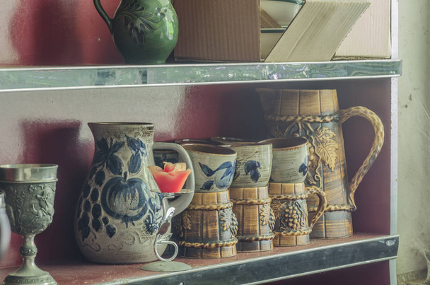 different vessels in a shelf of a house - Фото, изображение