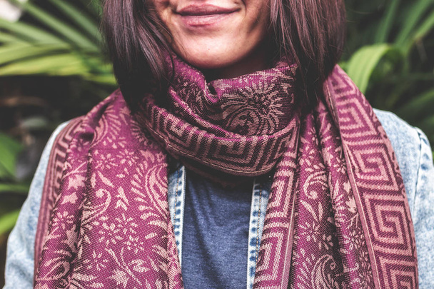 Woman wearing warm cashmere scarf on a tropical background. - Photo, Image