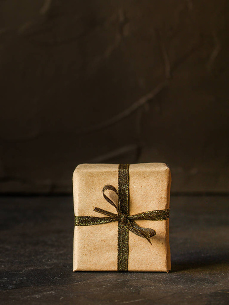 Gift Box with Ribbon - craft paper(dark background). top view, copy space - Zdjęcie, obraz