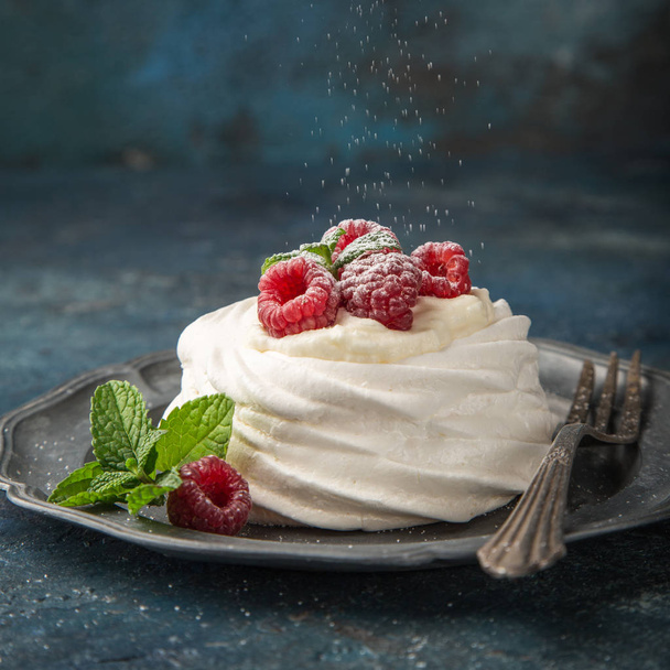 mini pavlova  meringue cakes with whipped cream and fresh raspberry, selective focus, square image - Φωτογραφία, εικόνα