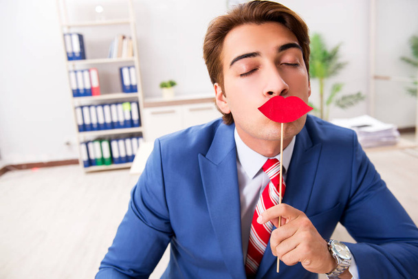 Funny bisinessman with fake lips in the office - Photo, Image