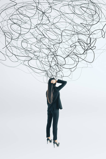 Thoughtful young businesswoman with scribble standing on white background. Confusion and think concept  - Zdjęcie, obraz