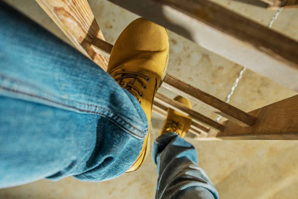 Construction Worker on Wooden Ladder. Shoes Closeup Photo.  - Photo, Image