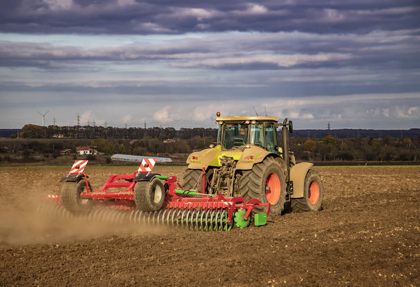 Трактор готовит почву для посева и возделывания. Сельское хозяйство и агрономия
. - Фото, изображение