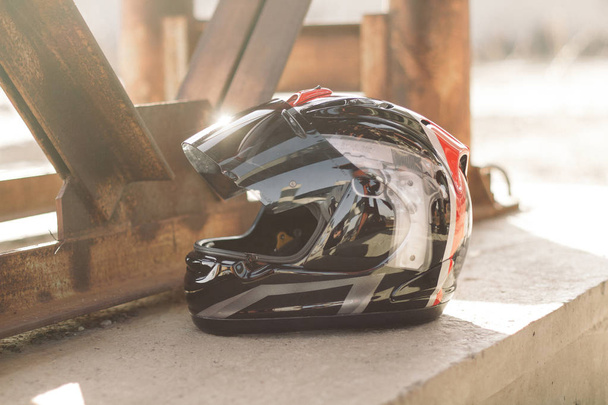 Modern motorcycle helmet on urban bright background - Photo, Image